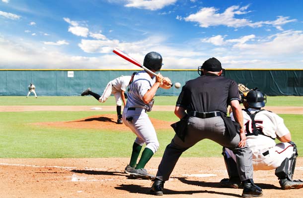 Spring Training Baseball scene. Pitch on its way with umpire, catcher, and batter waiting.