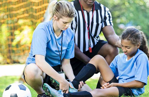 coach and ref with young biracial girl